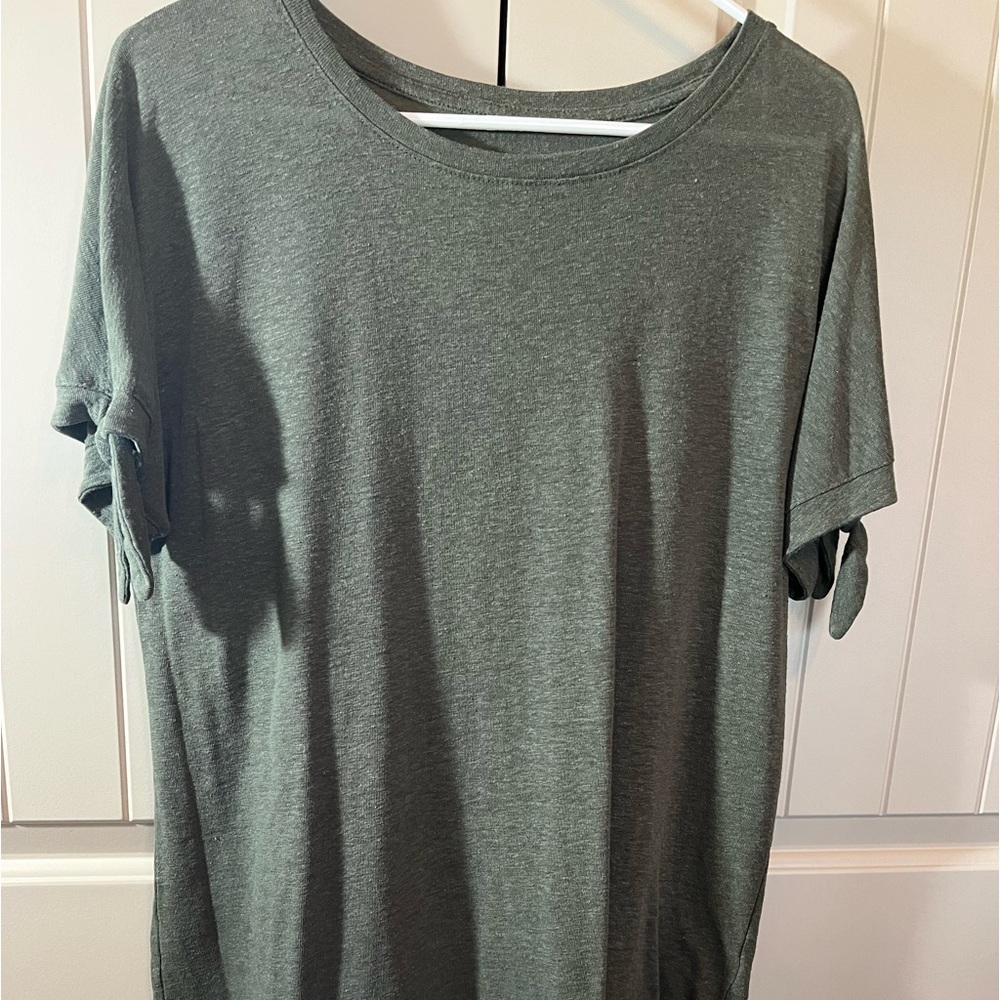 Women’s green top with ties on sleeves.